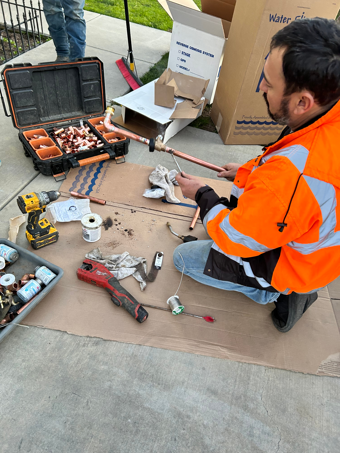 Home Valley installer soldering copper pipe for a reverse osmosis system